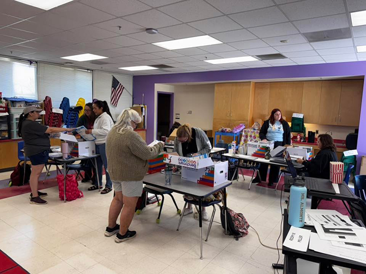 Teachers browse through curriculum in a classroom