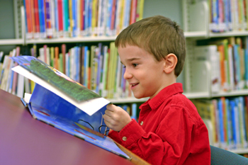 A Boy Reading In The Hudlow Library